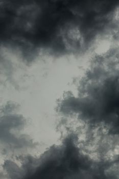 gray incoming storm clouds dark closeup vertical backdrop, captured on 100 mm telephoto lens