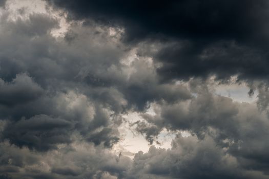 grey incoming storm clouds dark closeup backdrop, captured with normal lens