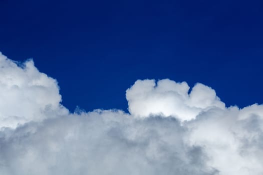 White cloud and blue sky at daylight. Close shot wit telehoto lens and polarizing filter with minimalistic composition.