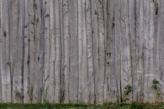 gray wooden weathered barn wall flat background template with green grass.