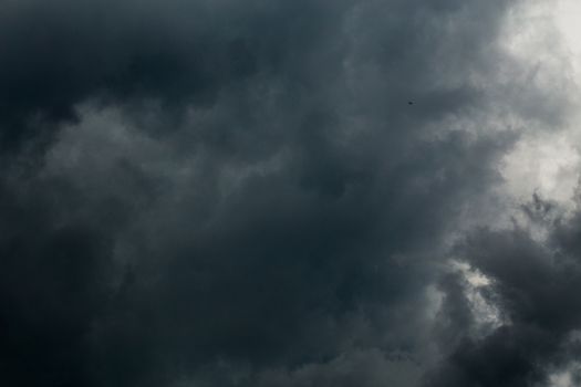 gray incoming storm clouds dark closeup backdrop, captured on 100 mm telephoto lens
