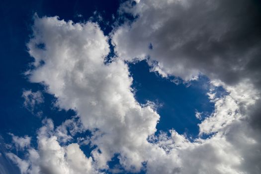 Regular spring clouds on blue sky at daylight in continental europe. Close shot with wide angle lens without any filter.