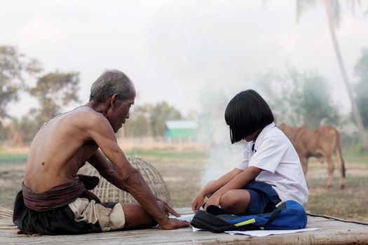 Oldman and girl in the countryside of Thailand.