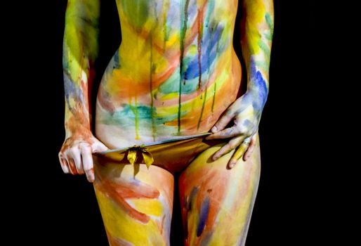 Body art. Drawing on the body. Beautiful girl with painted body watercolors. A white young girl painted the body with paint.