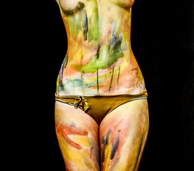 Body art. Drawing on the body. Beautiful girl with painted body watercolors. A white young girl painted the body with paint.