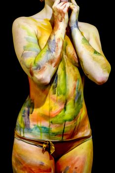 Body art. Drawing on the body. Beautiful girl with painted body watercolors. A white young girl painted the body with paint.