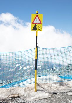 Sign warning of the danger of falling from the cliff, skiing