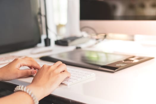 Woman hand using laptop to work study on work desk with clean nature background background. Business, financial, trade stock maket and social network concept.