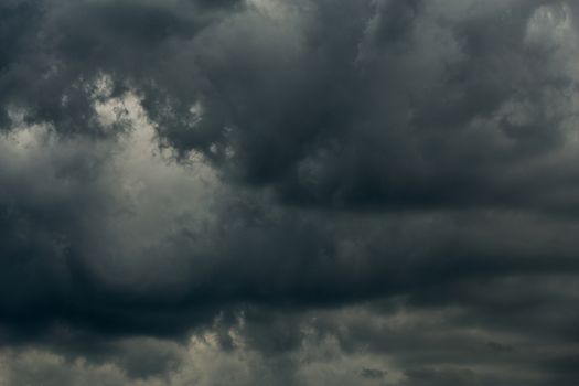 gray incoming storm clouds dark closeup backdrop, captured on 100 mm telephoto lens