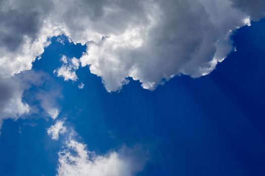 Regular spring clouds on blue sky at daylight in continental europe. Close shot wit telehoto lens and circular polarizing filter.