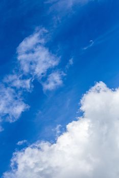 Regular spring clouds on blue sky at daylight in continental europe. Close shot wit telehoto lens and circular polarizing filter.