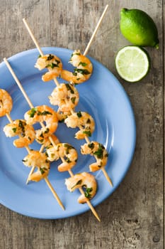 Shrimp skewers on wooden table