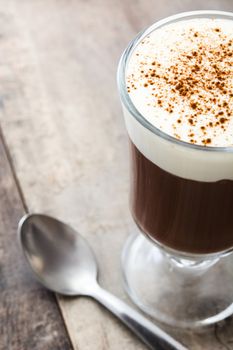 Irish coffee in glass on wooden table