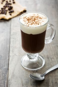 Irish coffee in glass on wooden table