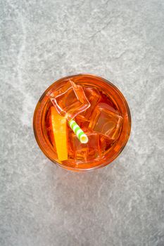 Aperol spritz cocktail in glass on gray stone