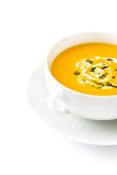 Pumpkin soup in white bowl isolated on white background