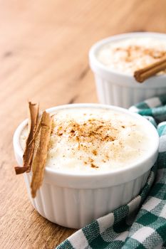 Arroz con leche. Rice pudding with cinnamon on wooden background