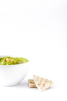 Avocado hummus in bowl isolated on white background