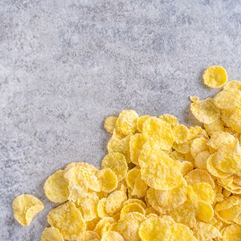 Corn flakes bowl sweets on gray cement background, top view flat lay layout design, fresh and healthy breakfast concept.