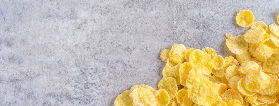 Corn flakes bowl sweets on gray cement background, top view flat lay layout design, fresh and healthy breakfast concept.