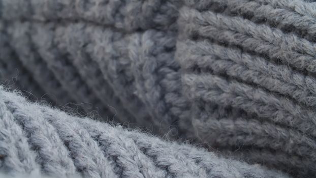 Extreme close up thick gray wool knitted sweater. Texture, textile background. Macro shooting