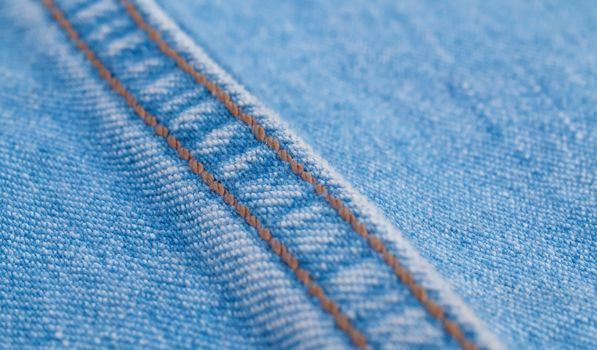 Extreme close up - double seam on jeans. Texture, textile background. Macro shooting