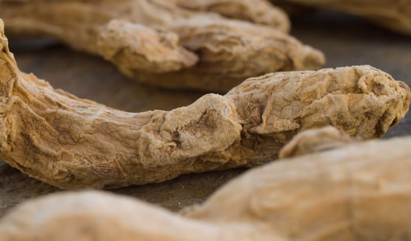 Macro shot of dried ginger roots - famous aromatic spice. Extreme close up