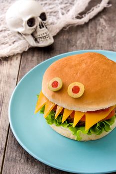 Halloween burger monsters on wooden table