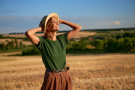 Woman farmer straw hat standing farmland smiling Female agronomist specialist farming agribusiness Happy positive caucasian worker agricultural field Pretty girl denim jeans green t-shirt harvest