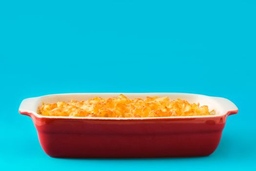 Typical American macaroni and cheese on blue background