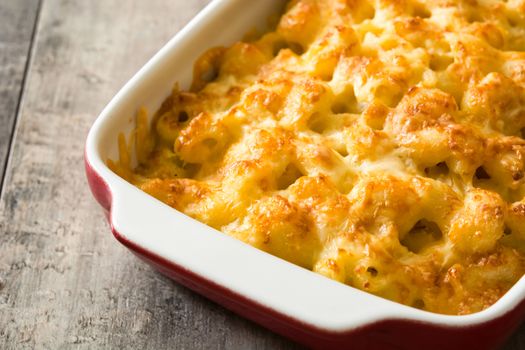 Typical American macaroni and cheese on wooden table