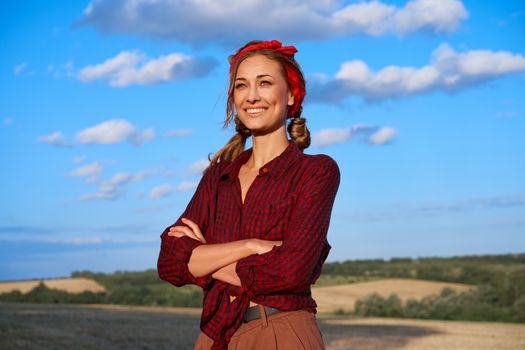Woman farmer standing farmland smiling Female agronomist specialist farming agribusiness Happy positive caucasian worker agricultural field Pretty girl dressed red checkered shirt and bandana