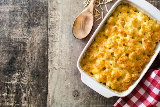 Typical American macaroni and cheese on wooden table