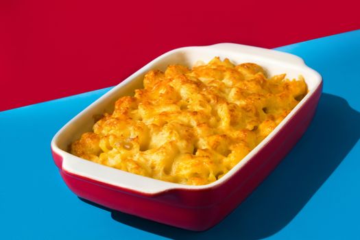 Typical American macaroni and cheese on blue and red background