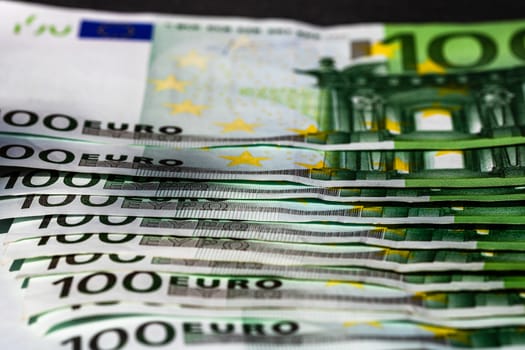 Selective focus on detail of euro banknotes. Close up macro detail of money banknotes, 100 euro isolated. World money concept, inflation and economy concept