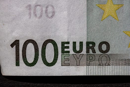 Selective focus on detail of euro banknotes. Close up macro detail of money banknotes, 100 euro isolated. World money concept, inflation and economy concept