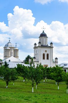 Pasarea monastery, orthodox church architectural details. View of Orthodox church and green churchyard.