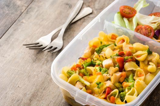 Lunch box with healthy food ready to eat Pasta salad on wooden table