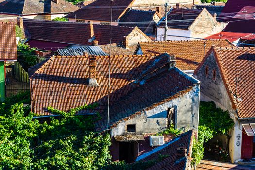 Overview of tile rooftops of old houses. Old buildings architecture.
