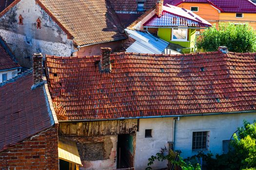 Overview of tile rooftops of old houses. Old buildings architecture.