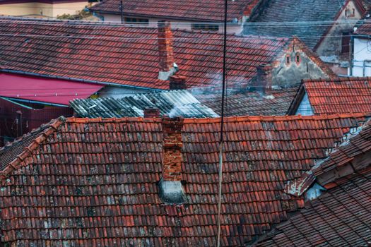 Overview of tile rooftops of old houses. Old buildings architecture.