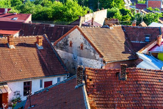 Overview of tile rooftops of old houses. Old buildings architecture.