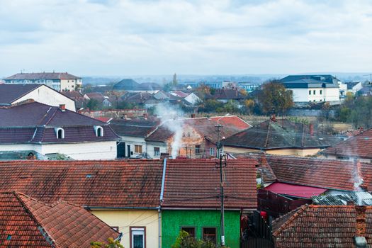 Overview of tile rooftops of old houses. Old buildings architecture.