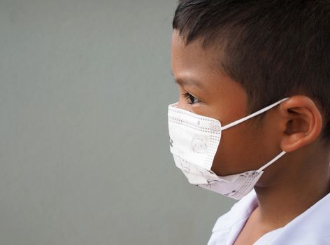 A close-up of a boy wearing a protective mask