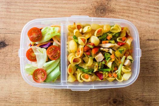 Lunch box with healthy food ready to eat Pasta salad on wooden table