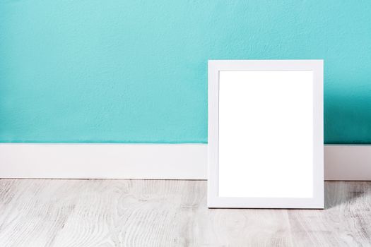 Frame mockup on white wooden table and blue background.