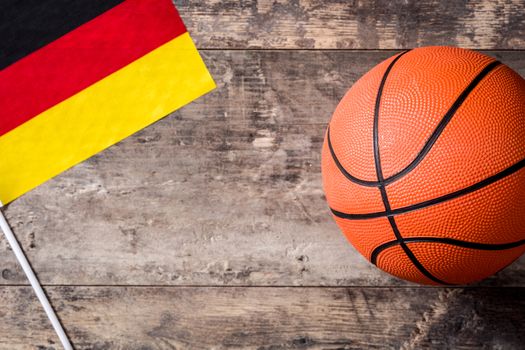 Basketball and German flag on wooden table. Top view. Copyspace