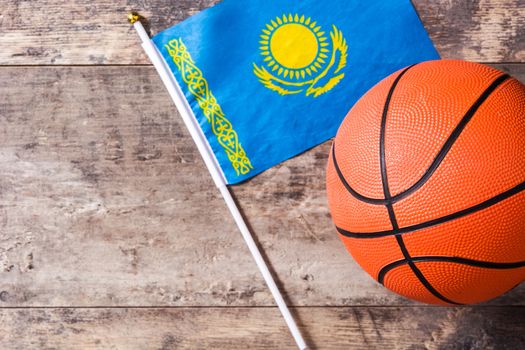 Kazakh flag and basketball on wooden table