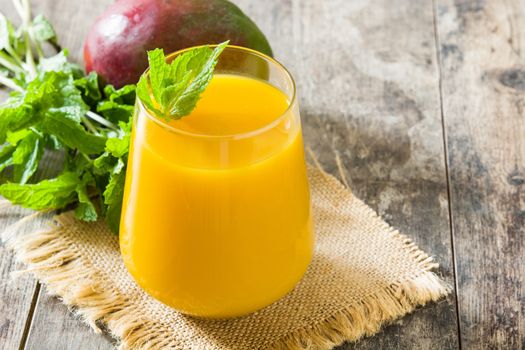 Mango Lassi dessert. Traditional Indian drink on wooden table. Copyspace