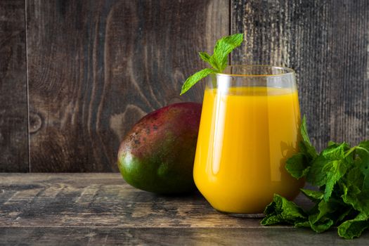 Mango Lassi dessert. Traditional Indian drink on wooden table. Copyspace